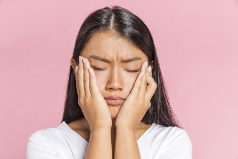 woman keeping her head in her palms